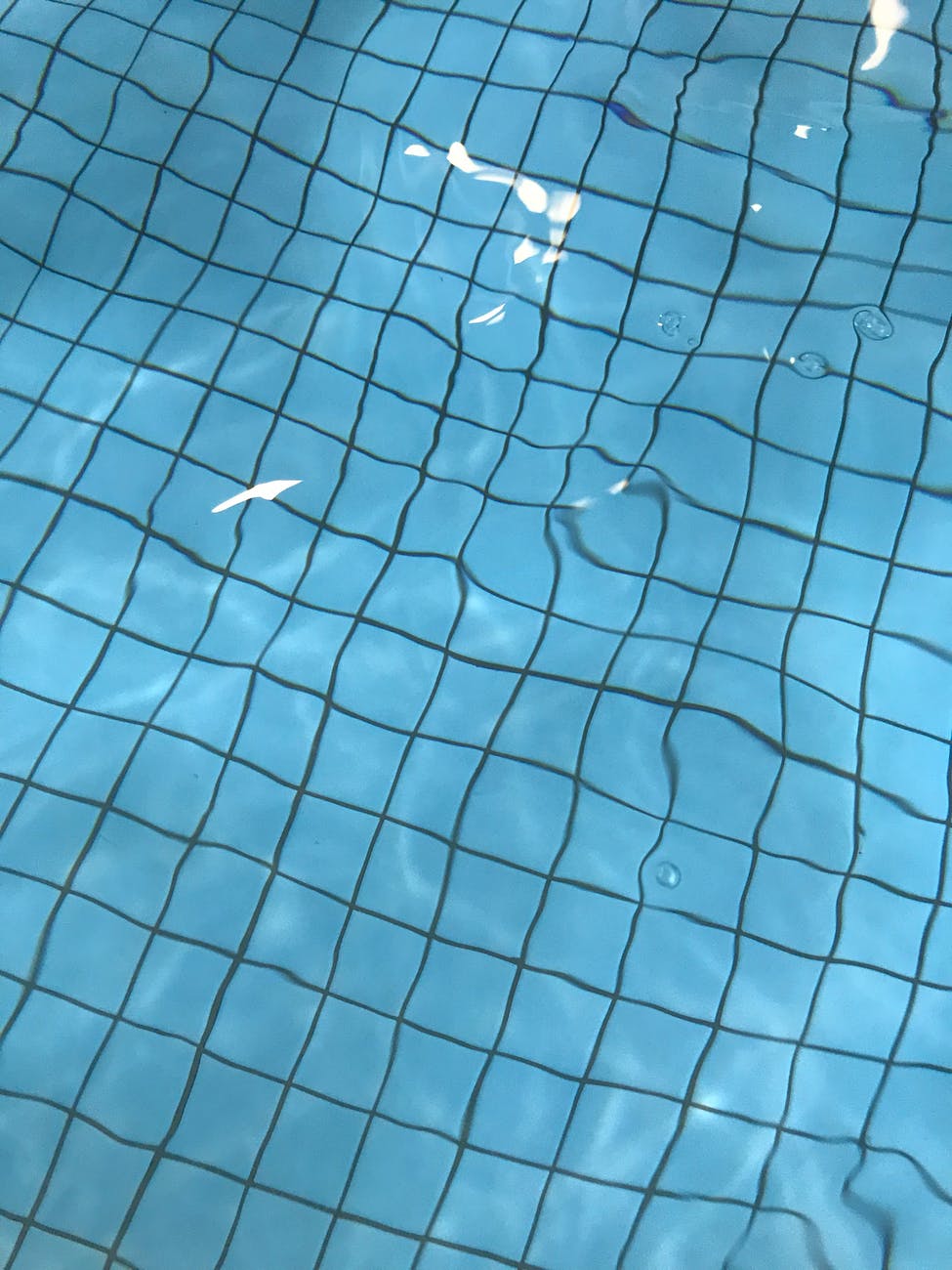 swimming pool with water and blue bottom